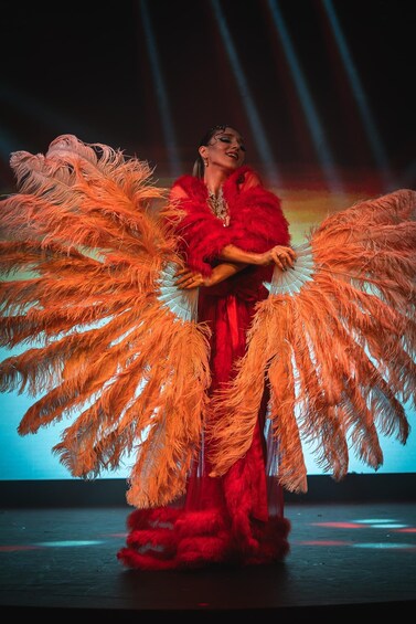 A person in a red costume with large orange feathered wings. 3