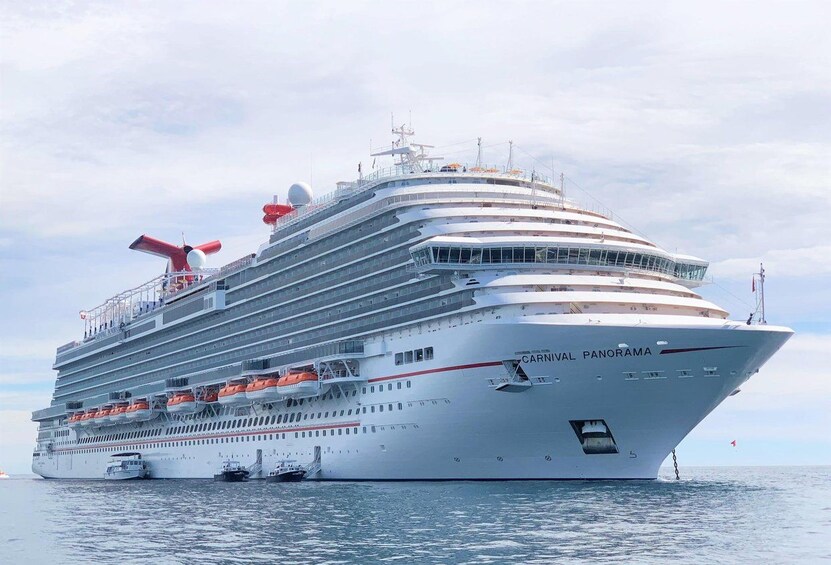 A large cruise ship named 'Carnival Panorama' with multiple decks and lifeboats visible. 3
