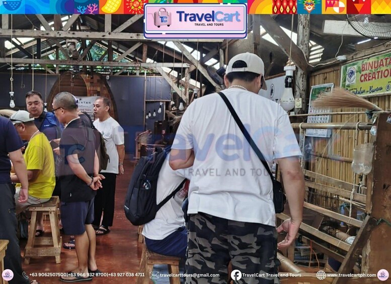 A busy indoor market with wooden stalls and a sign for 'TravelCart Travel and Tours'. 3