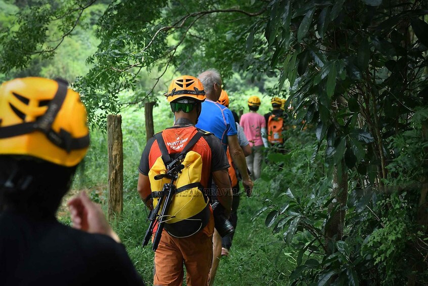 A group of people hiking in a forested area. 4