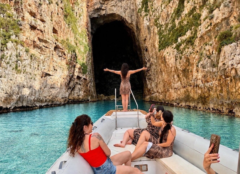 A boat with people enjoying a coastal cave. 1