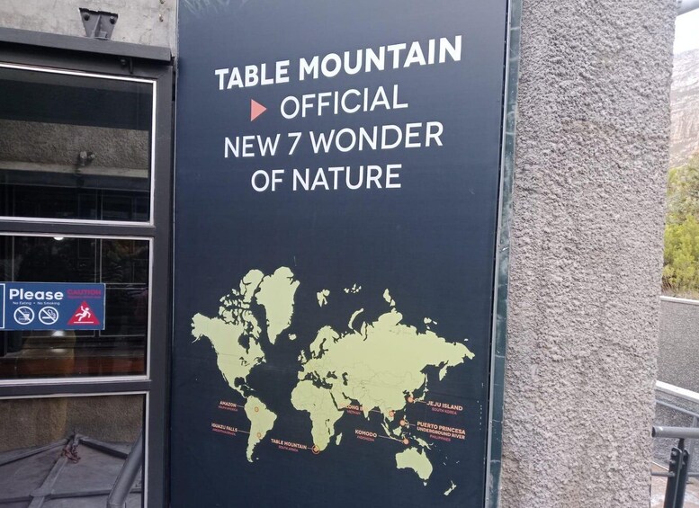 A signboard with a world map highlighting the Table Mountain as a new natural wonder. 1
