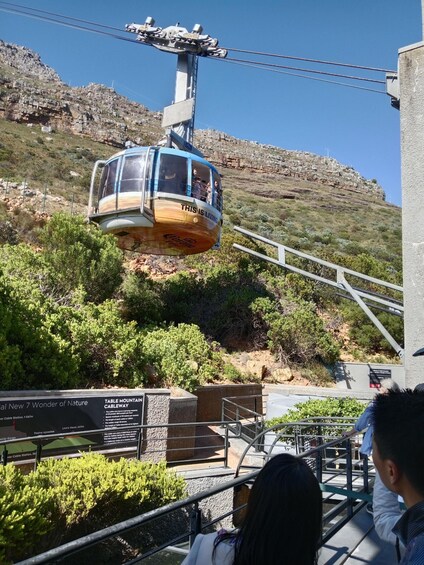 A cable car moving along a cableway with passengers. 4
