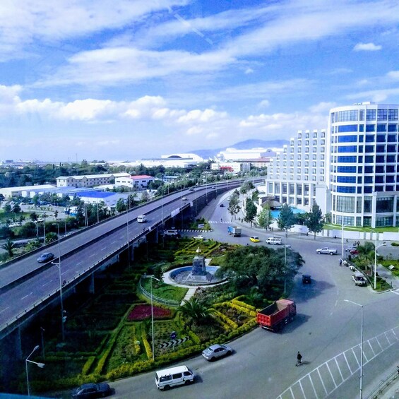 A cityscape with a highway, a roundabout, and modern buildings. 2