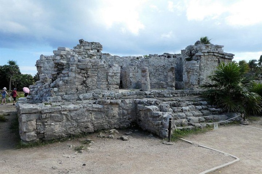 Ancient stone ruins with a pathway leading to them. 4