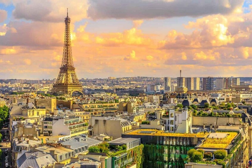 The Eiffel Tower in Paris with surrounding cityscape and a sunset sky. 1