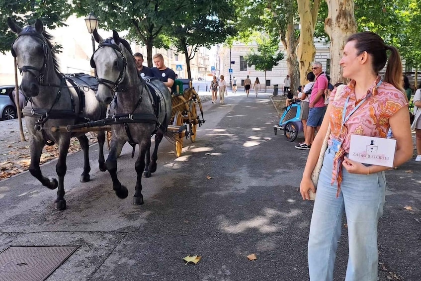 A street scene with a horse-drawn carriage and pedestrians. 3