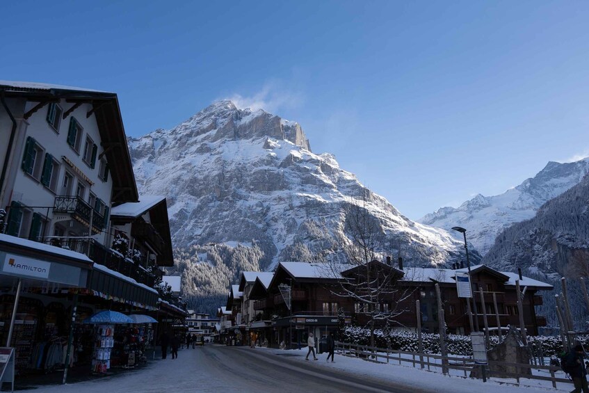 A snow-covered mountain town with buildings and a road. 2