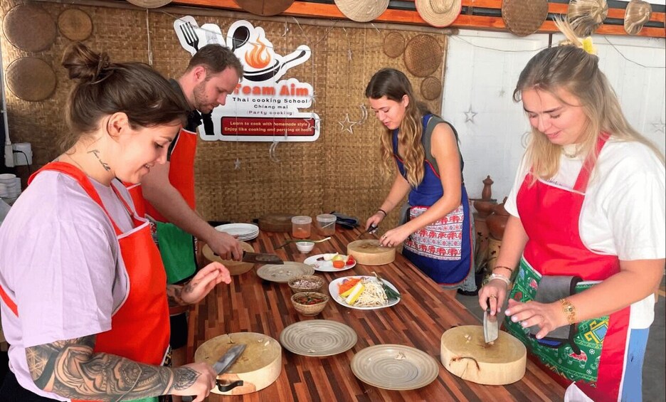 A group of people preparing food at a cooking school. 5