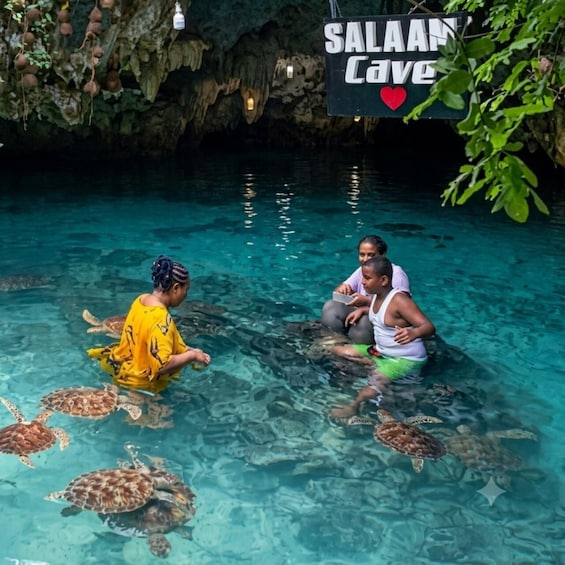 A cave with clear water, turtles, and a sign reading 'Salaam Cave'. 2