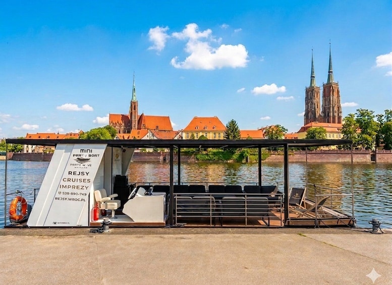 A boat docked near a historic building with two spires. 4