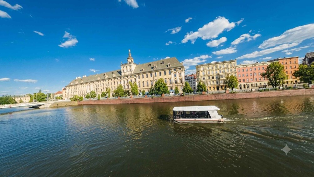 A river with a boat, a large historic building, and a clear blue sky. 3