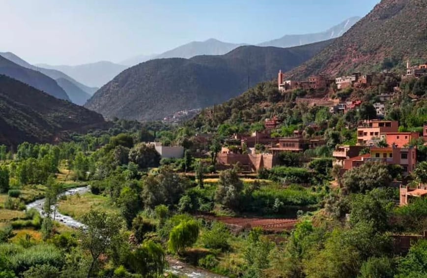 Un pueblo montañoso con campos en terrazas y un río. 2