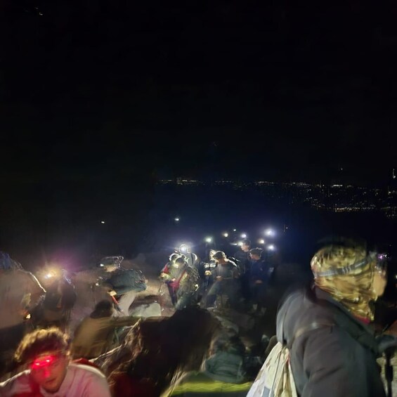 A nighttime outdoor gathering with people and bright lights. 5