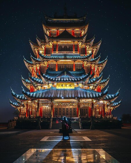 A multi-tiered pagoda with intricate architectural details and illuminated by warm lights against a starry night sky. 2