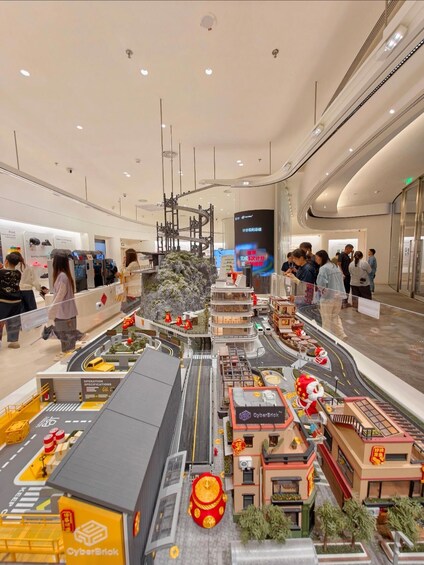 A model cityscape with buildings, roads, and a clock tower. 3