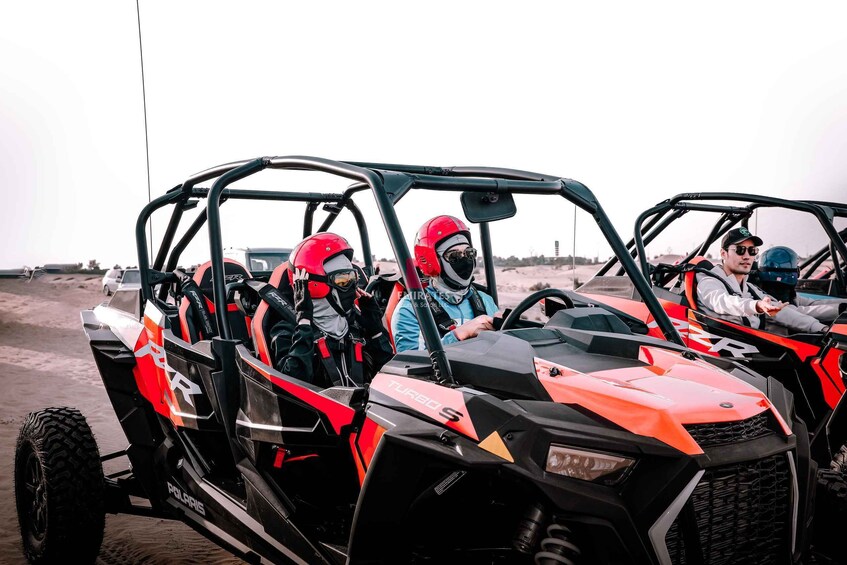 A Polaris Turbo S ATV with passengers wearing helmets. 5
