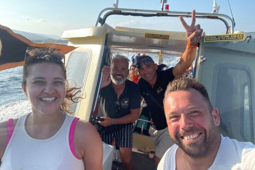 A boat with people on board, a clear sky, and water in the background. 4