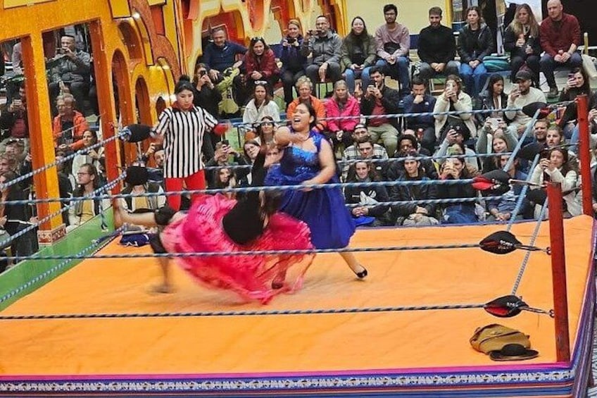 A wrestling match in a ring with an audience. 5
