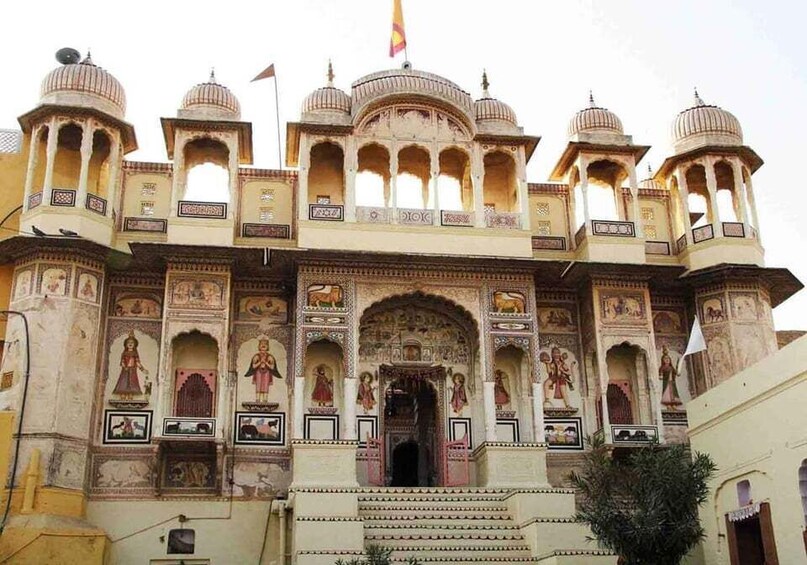A historic building with ornate architecture, including domes and detailed frescoes. 5