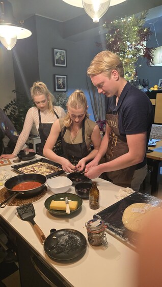 Three people preparing food in a kitchen. 2