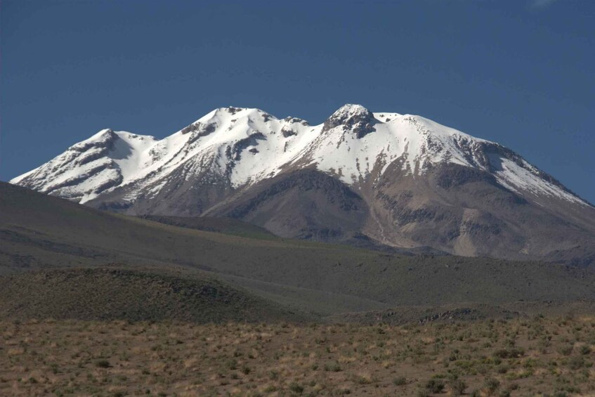 A snow-capped mountain with a clear sky. 3