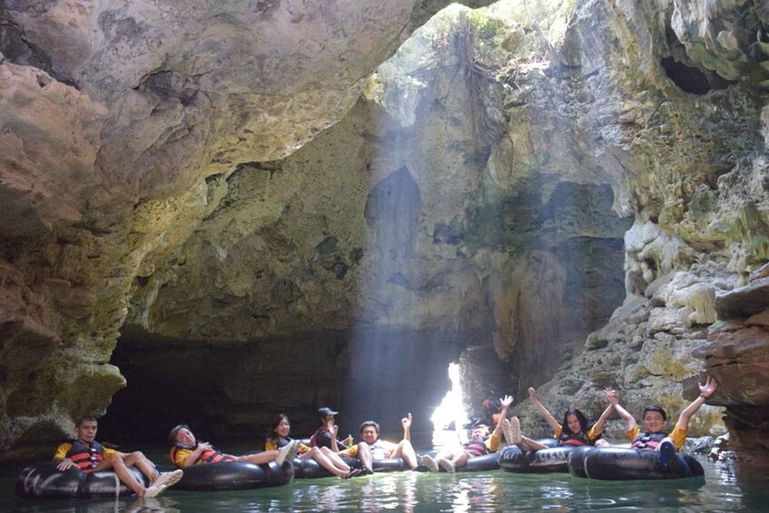 People floating on inner tubes in a cave. 3