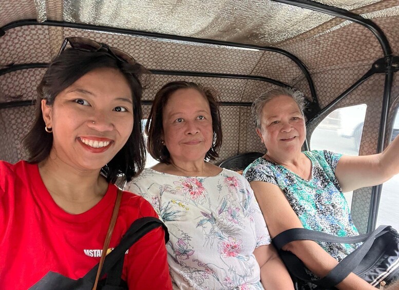 Three people seated in a vehicle with a patterned interior. 2