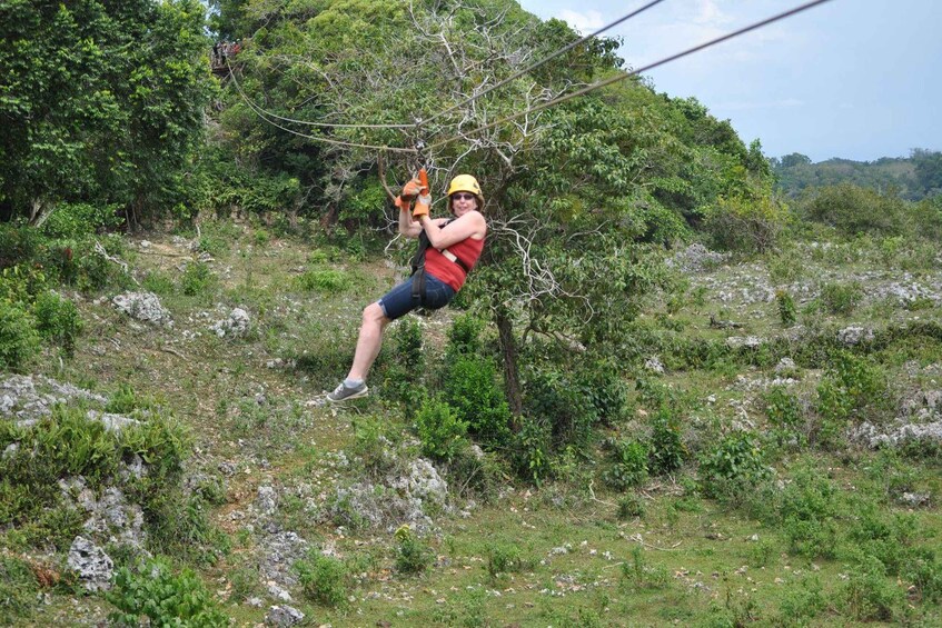 A person zip-lining through a forested area. 4