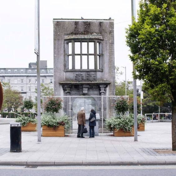 A historical monument with two people standing in front of it. 5