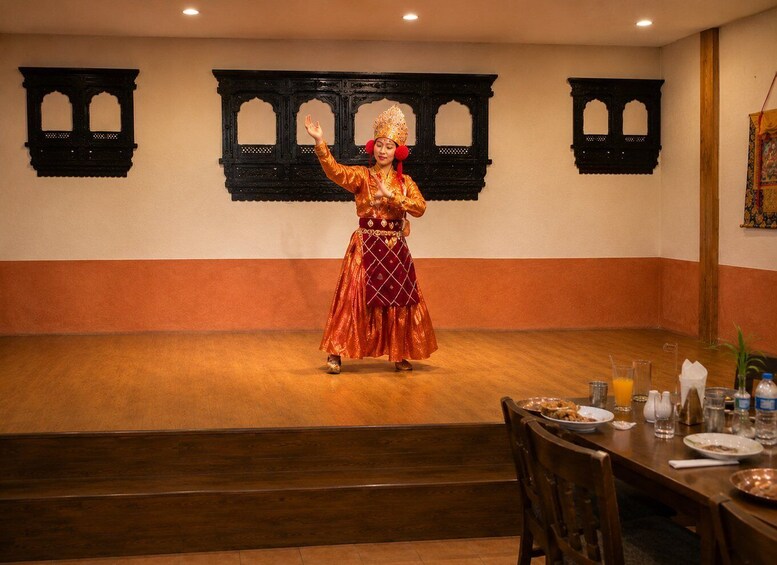 A person performing a dance in a room with traditional decor. 4