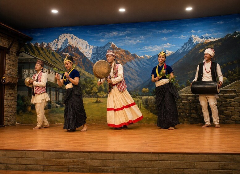 A stage with a backdrop of mountains and a building labeled 'ARUNA HOUSE'. 3