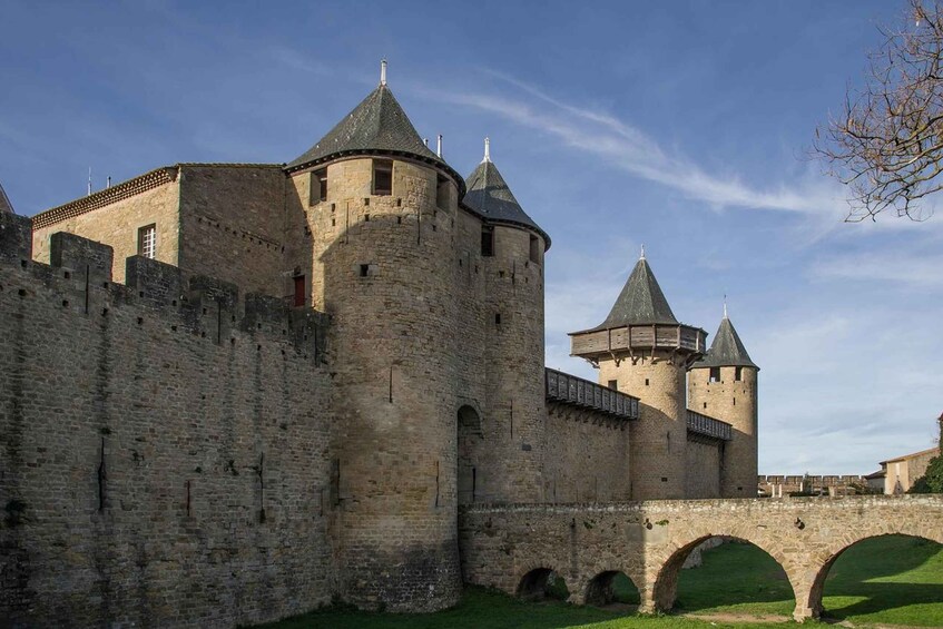 A medieval castle with multiple towers and a stone bridge. 3