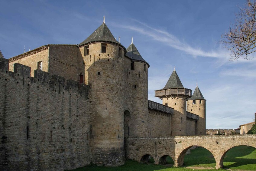 A medieval castle with multiple towers and a stone bridge. 2