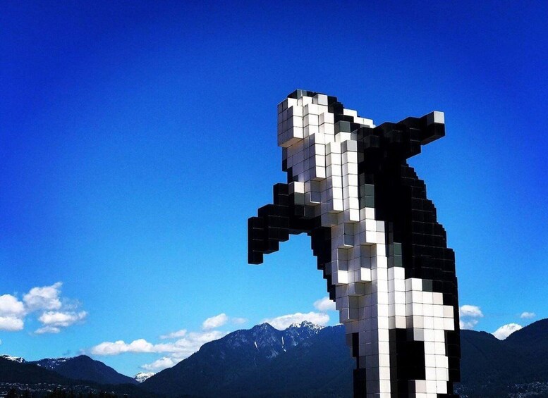 A pixelated sculpture of a horse against a mountain backdrop. 2
