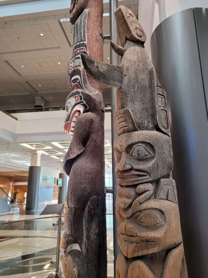Two totem poles in a modern building. 3