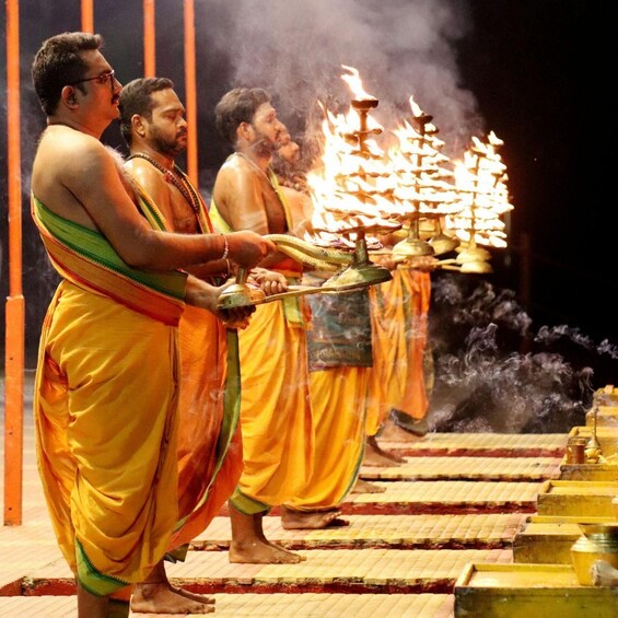 Men in traditional attire performing a ritual with a fire altar. 2