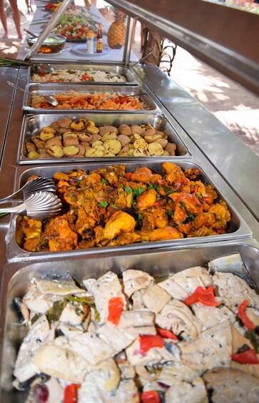 A buffet with various dishes including rice, vegetables, and meats. 5