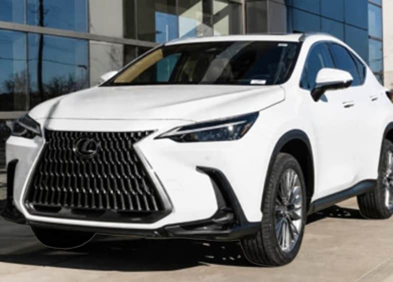A white Lexus SUV parked in front of a modern building with large glass windows. 3
