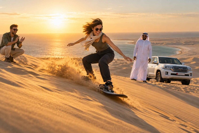A person snowboarding down a sand dune with a sunset in the background. 2