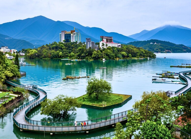 A lake surrounded by mountains, a bridge, and buildings. 3