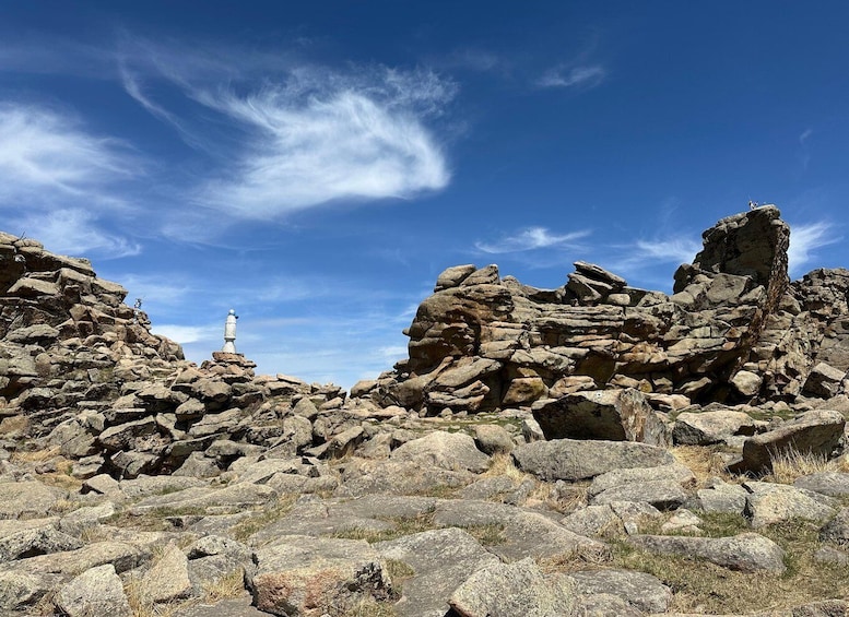 A rocky landscape with a lighthouse in the distance. 3