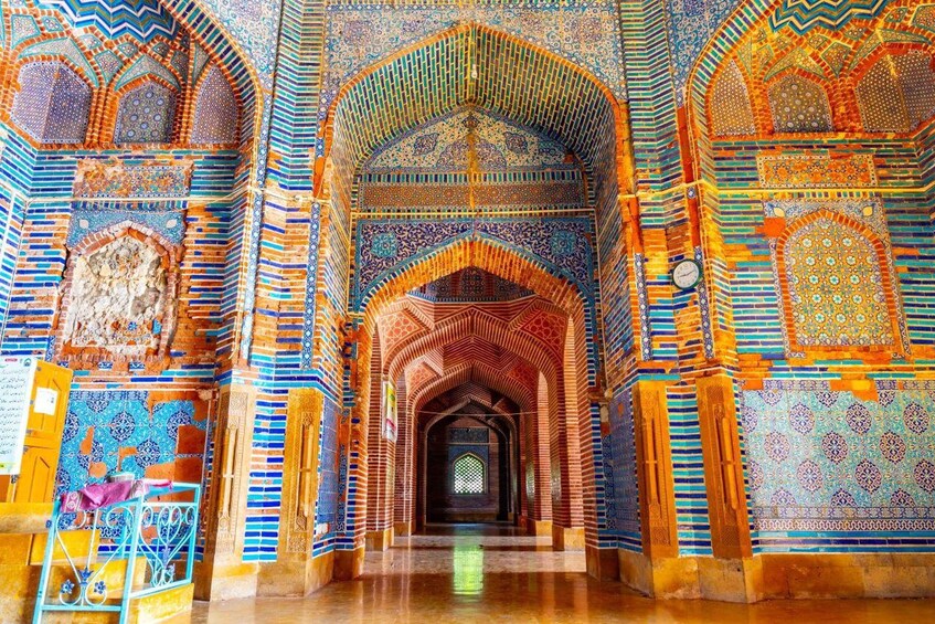An intricately decorated interior with vibrant tile work and arches. 4