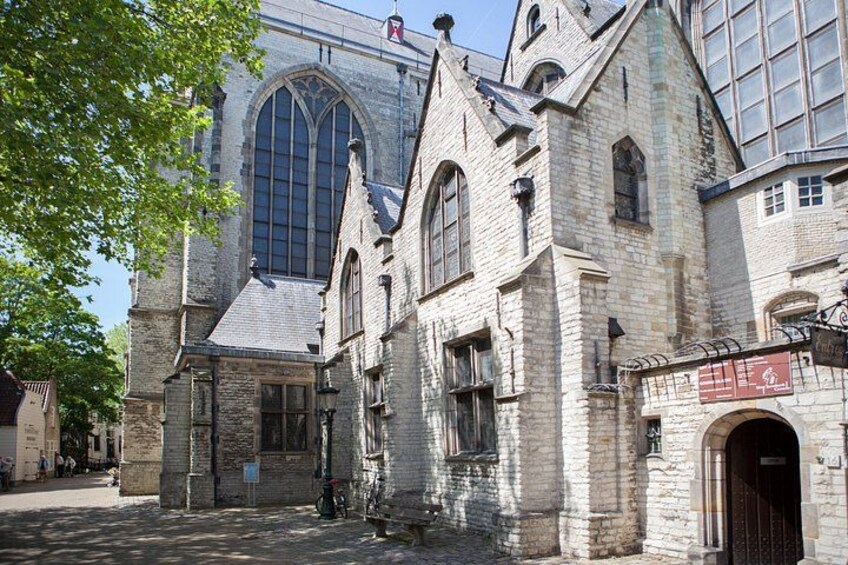 A historic stone building with arched windows and a large central window. 5
