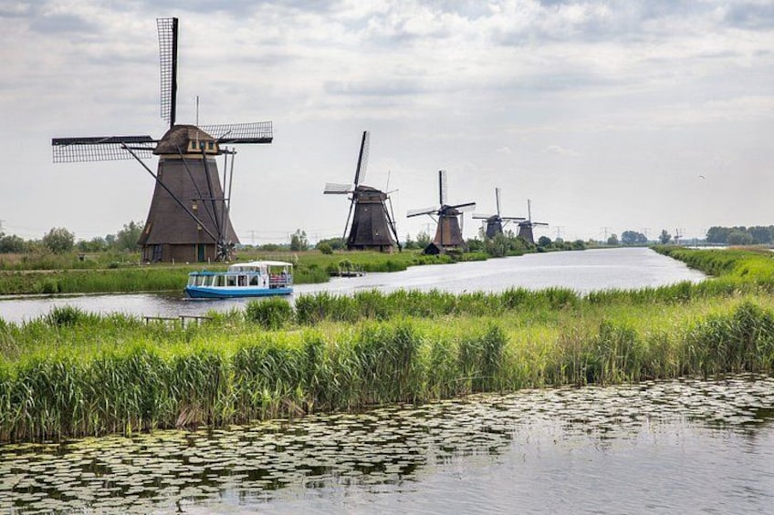 Windmills, a river, and a boat. 1