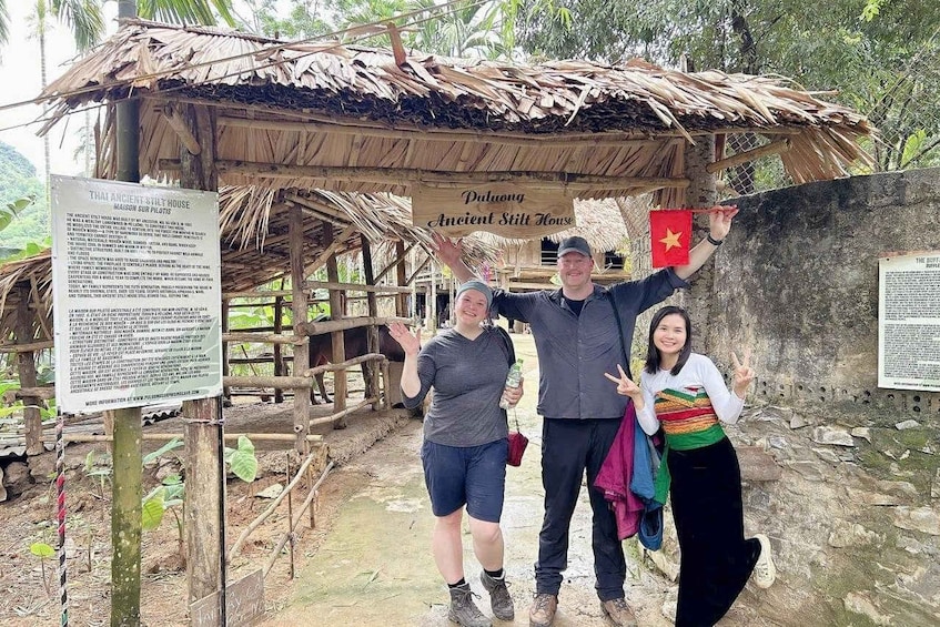 A traditional house with a thatched roof, a sign reading 'Dau Phuoc Ancient Still House,' and a Vietnamese flag. 4