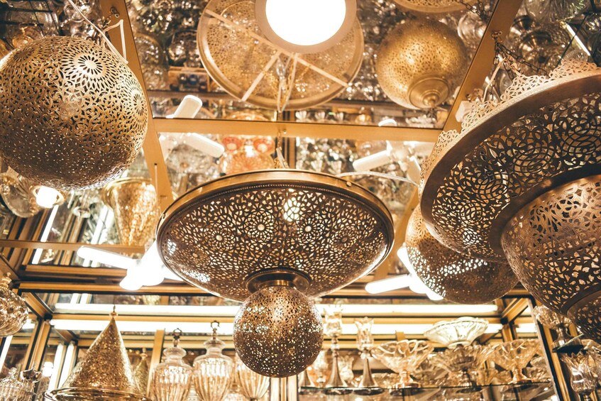 Ornate hanging lamps and decorative glassware in a store. 2