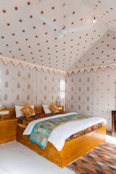 A bedroom with a wooden bed, patterned wallpaper, and a ceiling with star designs. 4