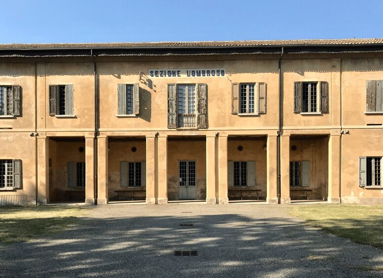 A building with the sign 'SEZIONE LOMBROSO' and multiple windows with shutters. 2
