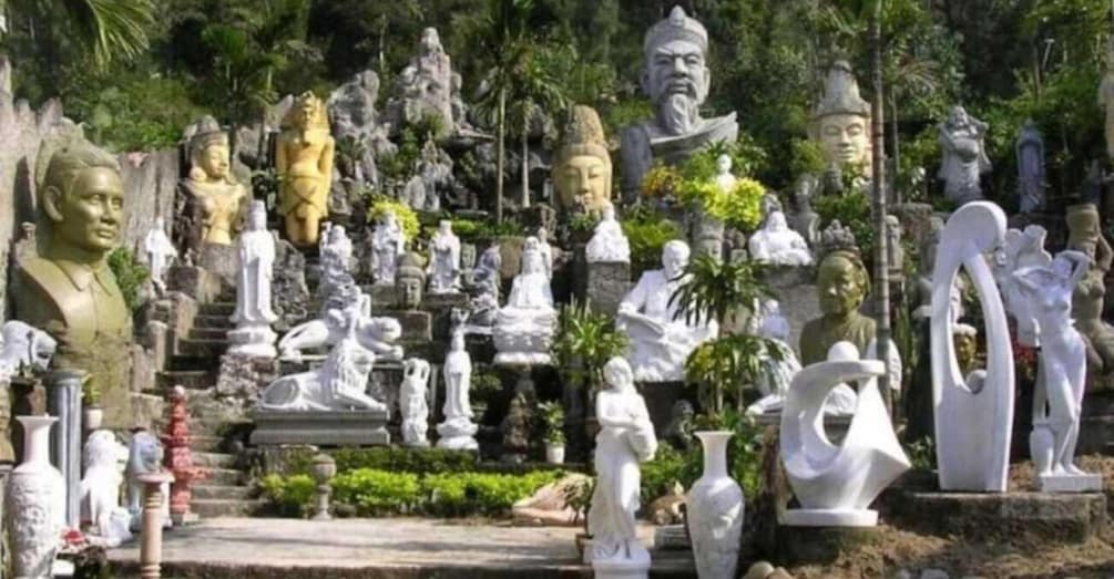 A collection of statues in a garden setting. 2